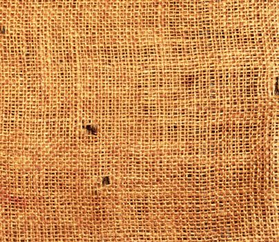 Old torn flaxen sackcloth as natural background