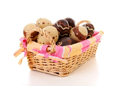 Cane basket with easter eggs over white background