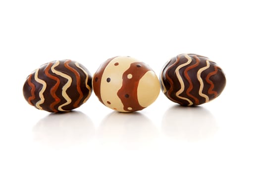 Three brown easter eggs over white background