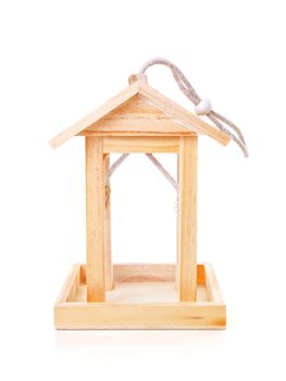 Empty wooden bird feeder house over white background