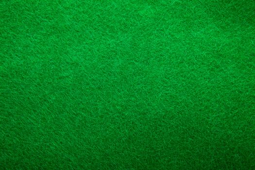 Background texture of green felt casino table in closeup