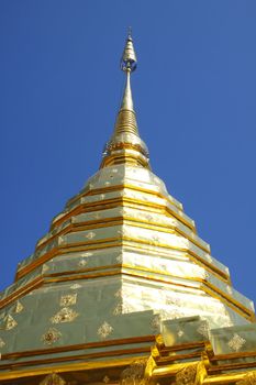 The golden pagoda with blue sky at Wat Phra That Doi Suthep, Temple Chiang Mai Province north Thail. Wat Phra That Doi Suthep contains the Holy Buddha Relic