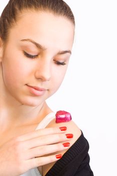 Valentines day girl with chocolate heart candy on her shoulder