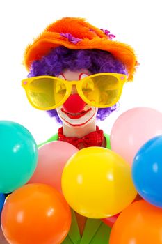 portrait of child dressed as colorful funny clown over white background
