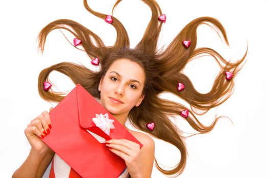 Young girl with red valentine's envelope and little chocolate hearts