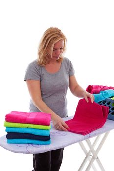 Housewife is folding colorful towels over white background