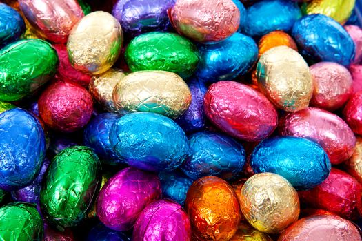 colorful chocolate easter eggs in closeup can be used as background 
