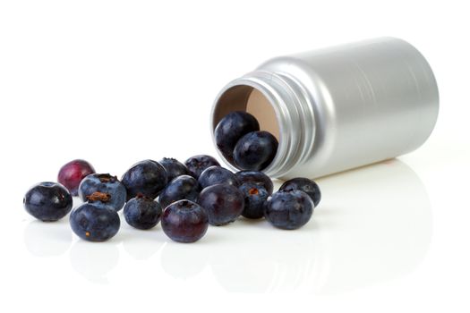 Conceptual; black currant berries as pills over white background