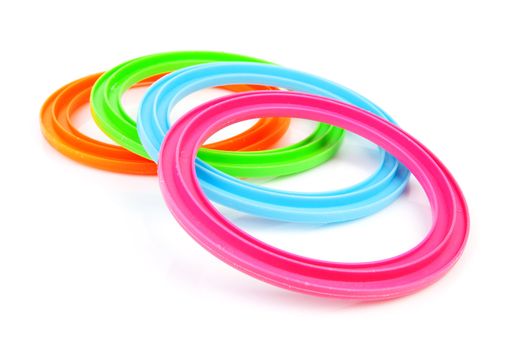 Four colorful plastic rings over white background