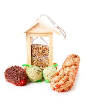 wooden bird feeder house with food over white background