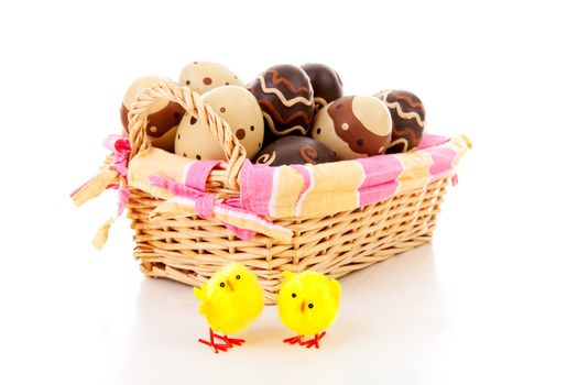 Cane basket with easter eggs over white background