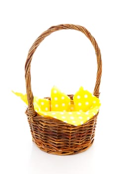 Empty cane basket with yellow napkin isolated on white background