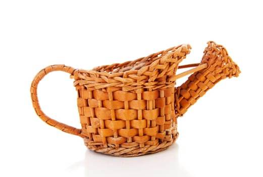 Old cane watering can over white background
