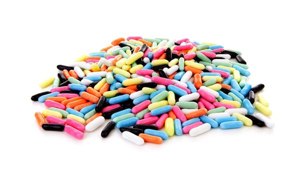 Pile of colorful laces rods candy over white background
