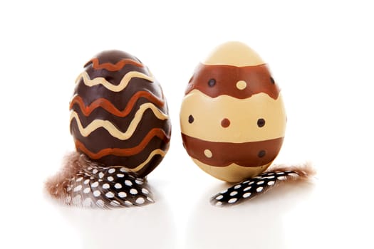 Two brown decorated easter eggs over white background