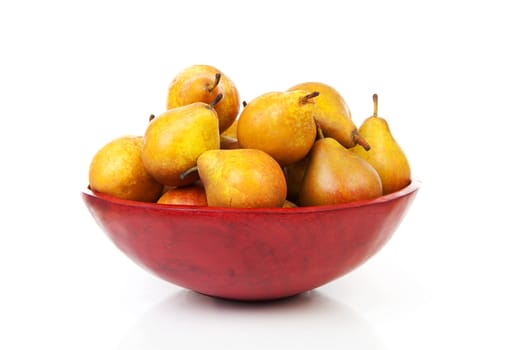 Red bowl with fresh pears over white background