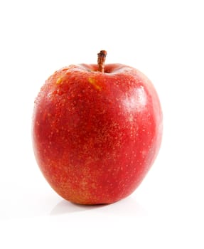 One red apple with water drops over white background