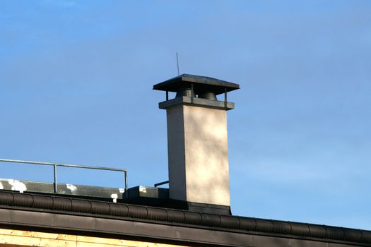 The roof and chimney with blue sky