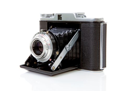 Old fashioned photo camera on white background 
