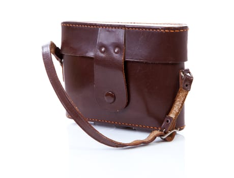 Old brown leather photocamera bag over white background