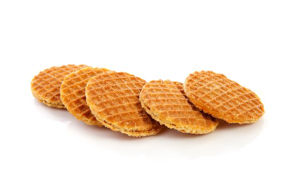 Pile of typical Dutch stroopwafels ( with syrup) over white background