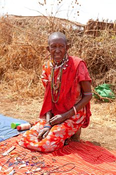AFRICA, KENYA, MASAI MARA - JULY 2: Masai woman is showing traditional jewelry as cultural ceremony near to Masai Mara National Park Reserve, July 2,2011,Kenya