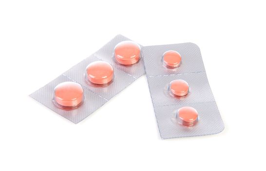 malaria pills in closeup over white background