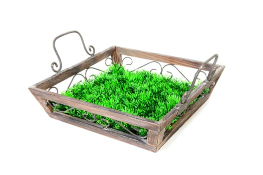 Empty wooden tray with grass over white background