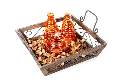 Tray with orange vases and decoration over white background