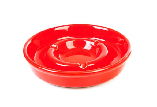 One empty red ashtray over white background