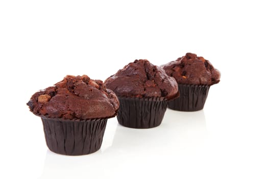 Three chocolate cupcakes isolated on white background