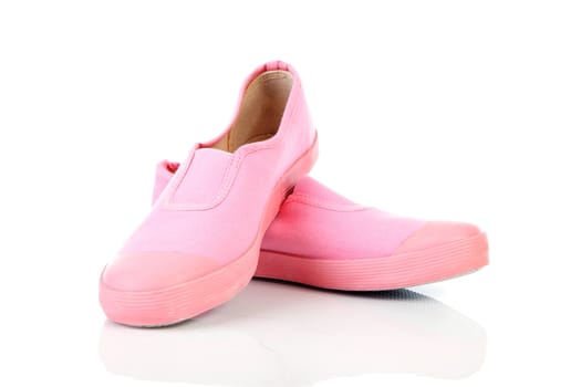 Pair of pink gym shoes over white background