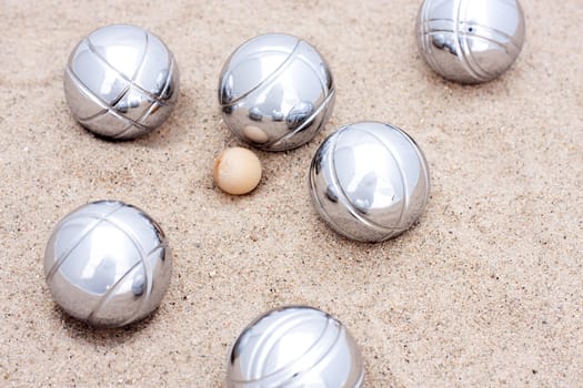 Game of jeu de boule, silver metal balls in sand. A french ball game 
