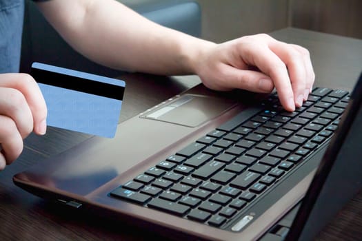 Man hand on keyboard with credit card