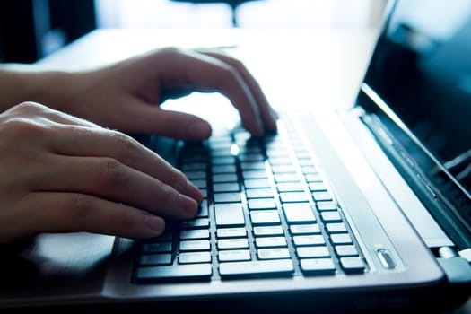 Close-up of human hands on keyboard