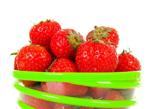 Bowl with fresh strawberries in closeup over white background
