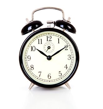 Black alarm clock over white background
