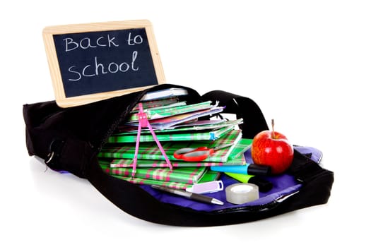 back to school: blackboard slate on bag with books with apple over white background 
