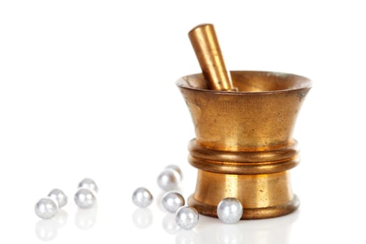Copper mortar with round medicine isolated on white background