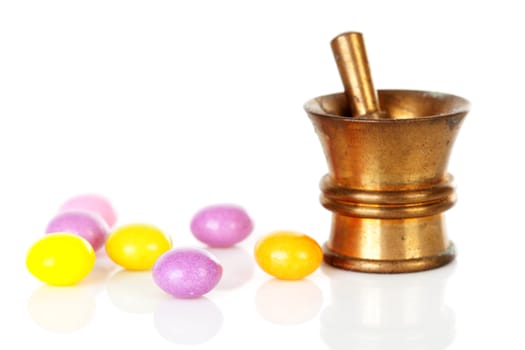 Copper mortar with colorful medicine isolated on white background