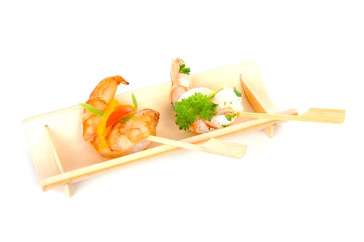 Little prawn snacks on wooden tray over white backgorund