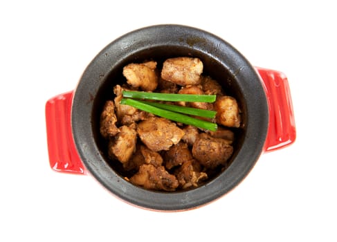 Baked chicken cubes in pan over white background