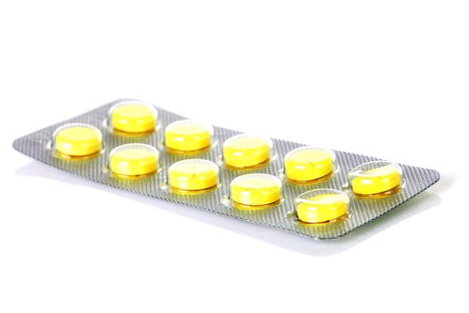 Yellow medicine strip isolated on white background 
