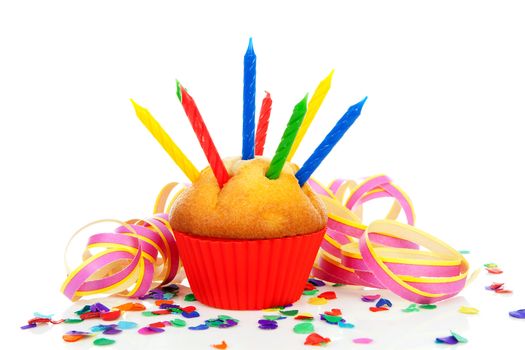 Birthday cupcake with lots of candles, party streamers and colorful confetti over white background