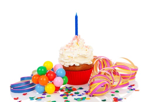 Birthday cupcake with whipped cream, party streamers and colorful confetti over white background