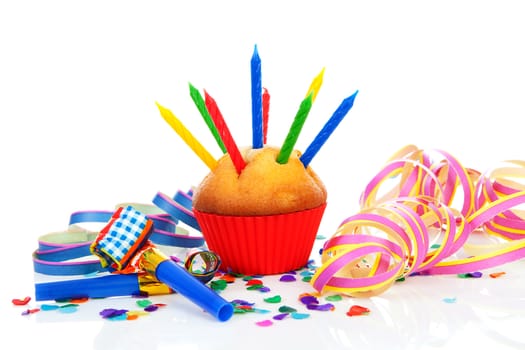 Birthday cupcake with lots of candles, party streamers and colorful confetti over white background