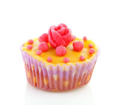 cupcake with marzipan roses decoration over white background 