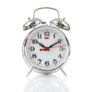 Silver alarm clock over white background
