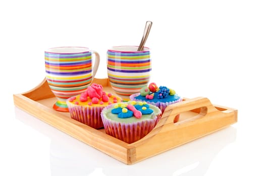 Tray with delicious decorated colorful cupcakes and cup of coffee over white background