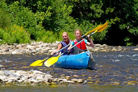 Two people in canoe enjoying holidays and nice weather in the Ardeche